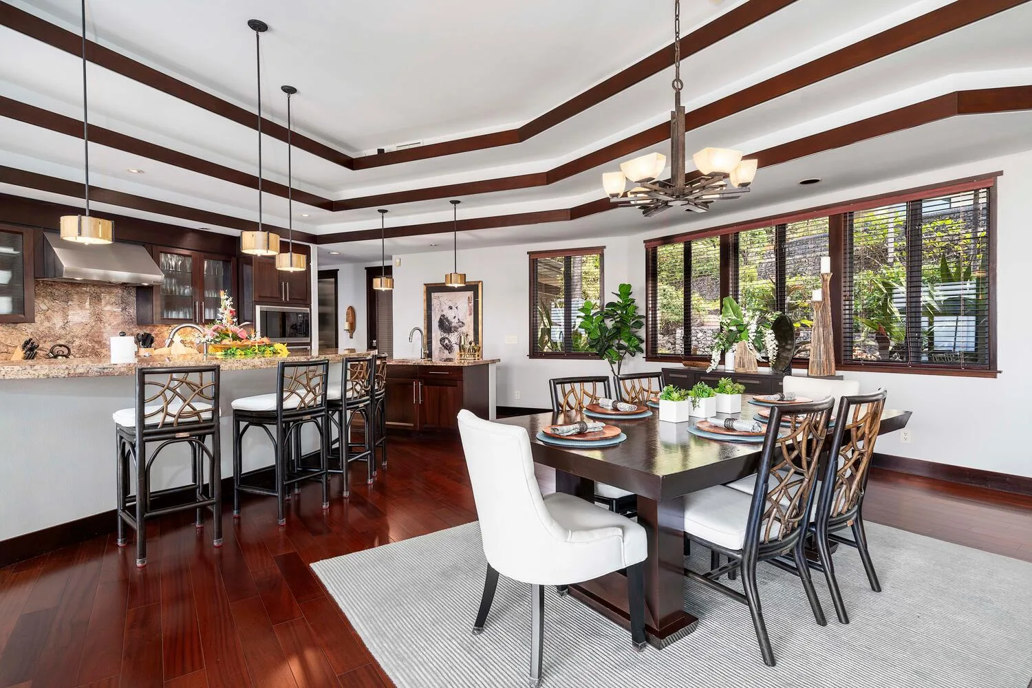 Comedor con una mesa y sillas junto a una isla de cocina.