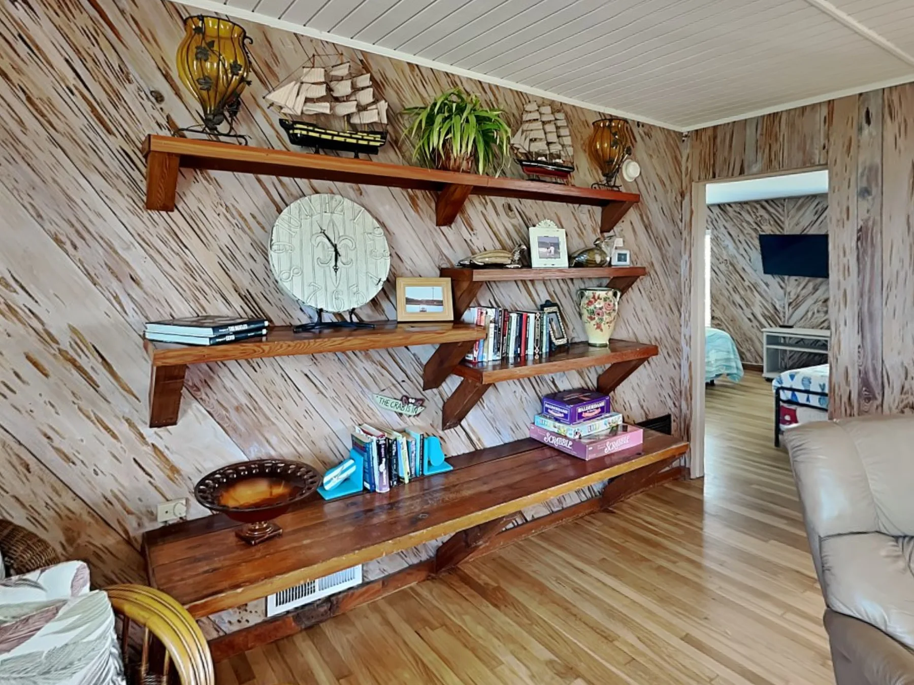 Una sala de estar con estantes de madera que exhiben libros y objetos decorativos.