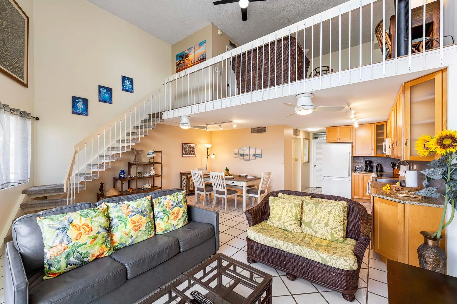 A living and dining area with a staircase leading to an upper level.