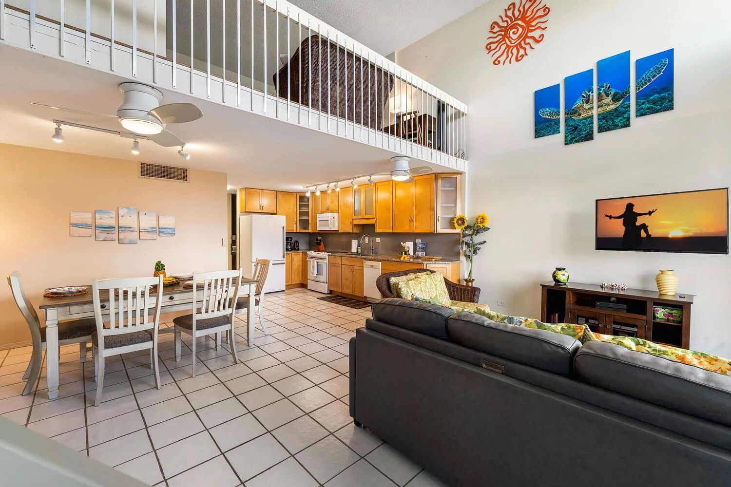 An open-plan living and dining area with a kitchen and mezzanine above.