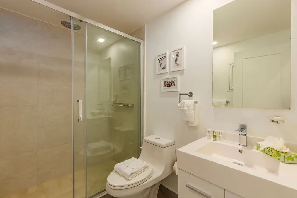 Step into your bright, modern bathroom with a spacious walk-in shower, crisp white finishes, and fresh towels waiting for you after a long day of exploring.
