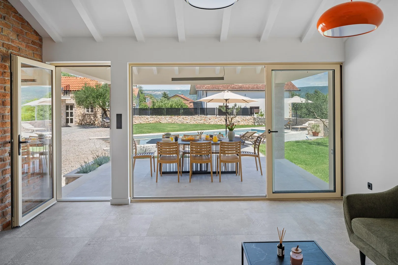 A direct sliding door toward the outdoor dining area and the pool