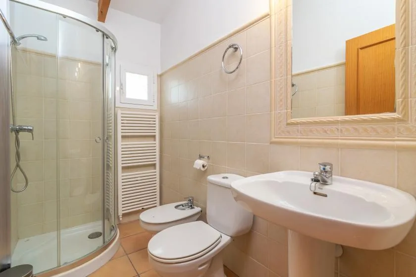 A bathroom with a sink, toilet, and glass shower.