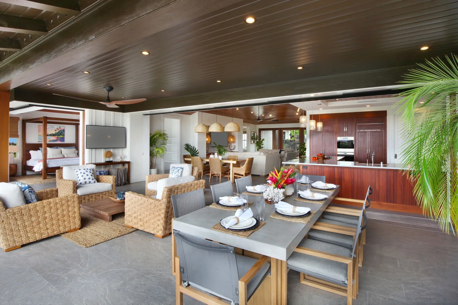 An open-plan living, dining, and kitchen area with a set dining table.