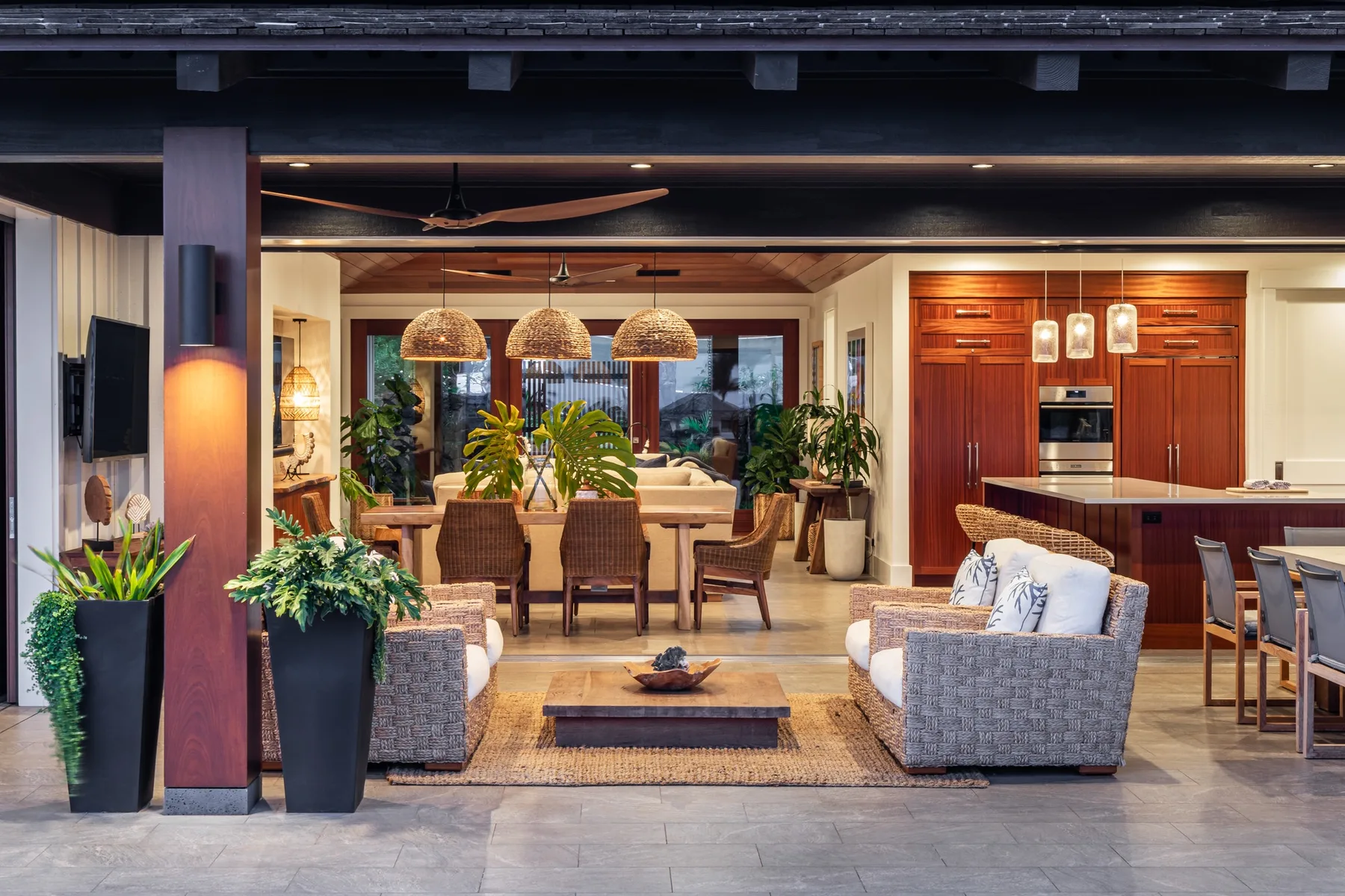 An open-plan living and dining area with a kitchen in the background.