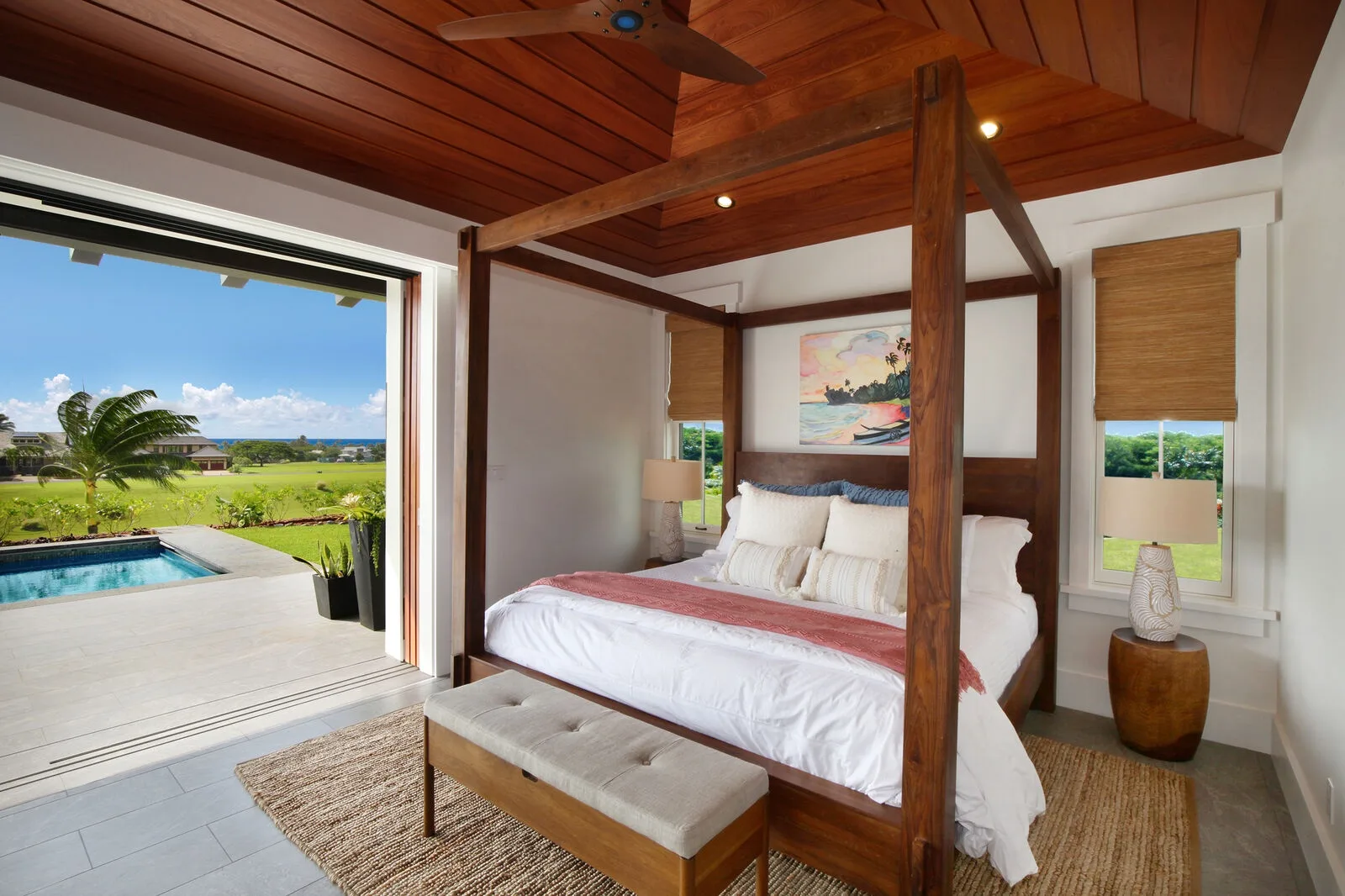 A bedroom with a four-poster bed and an open view of a pool and garden.