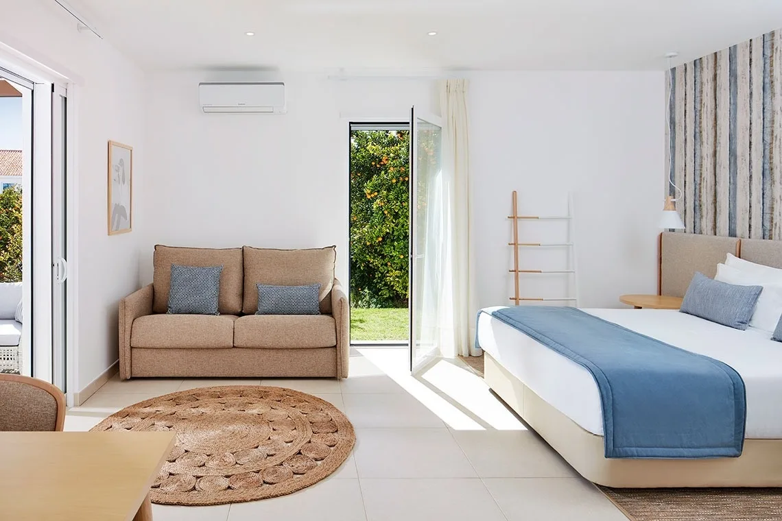 Double room with wood-effect wall covering and yellow throw.