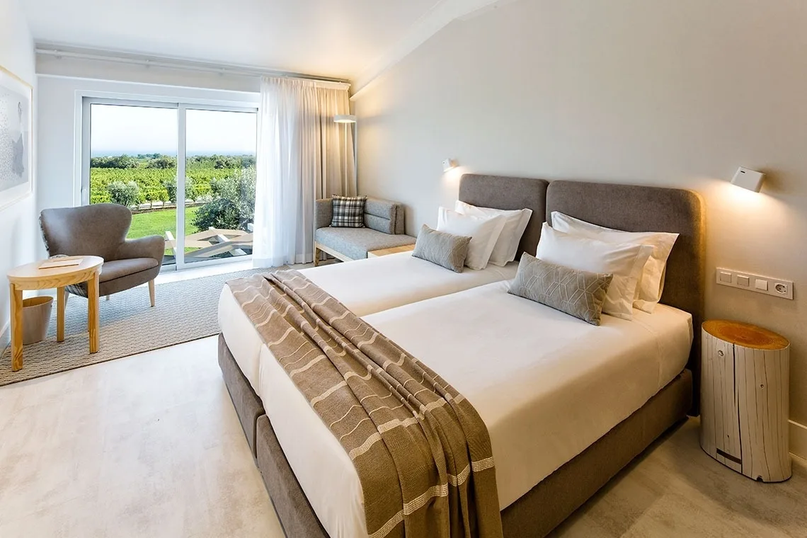 Guest room with a canopy bed, artwork and wood details.