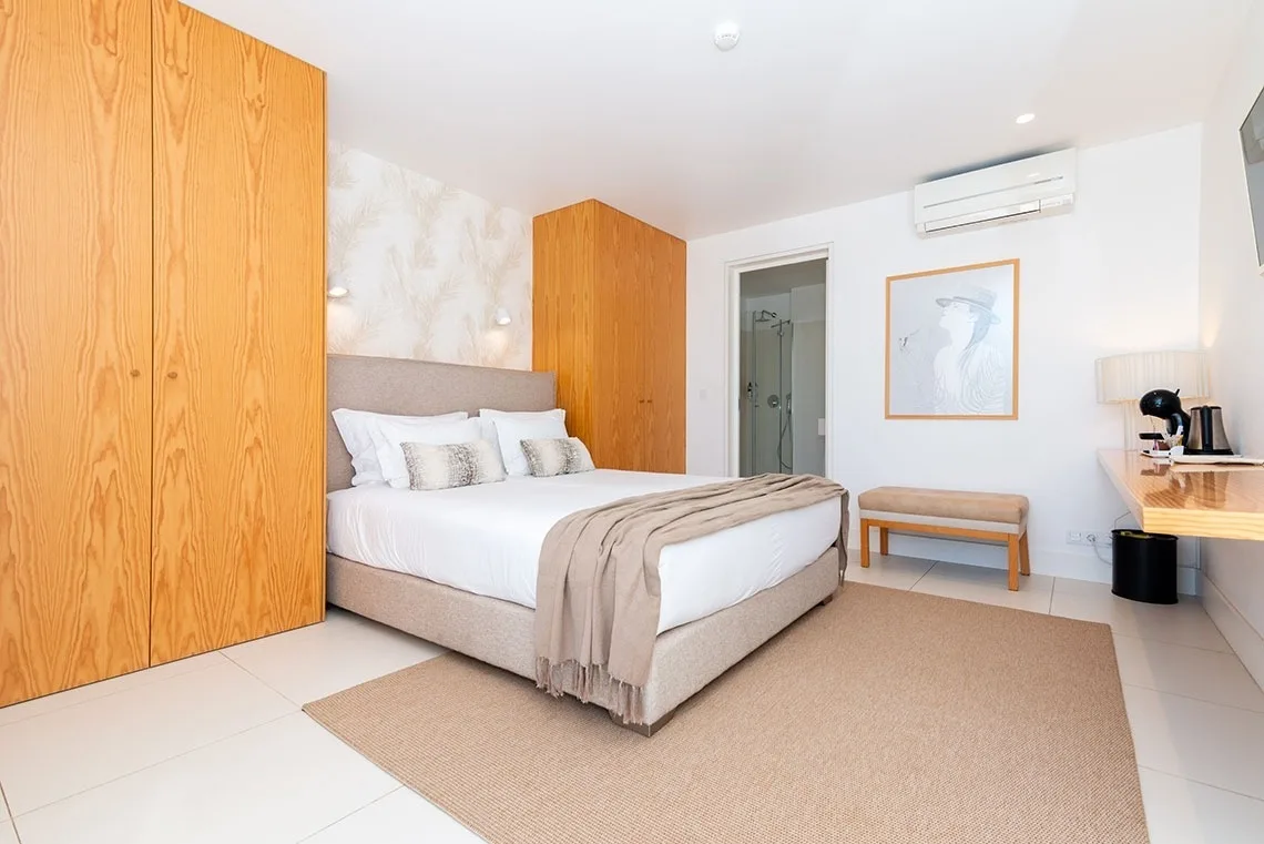 Guest room with a king bed and built-in wardrobe.