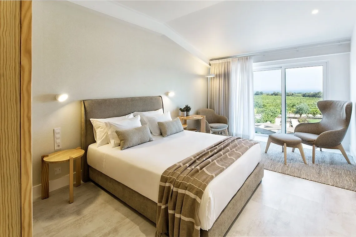 Guest room with a canopy bed, artwork and wood details.