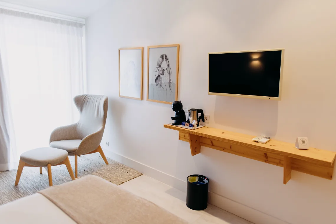 Guest room with a canopy bed, artwork and wood details.