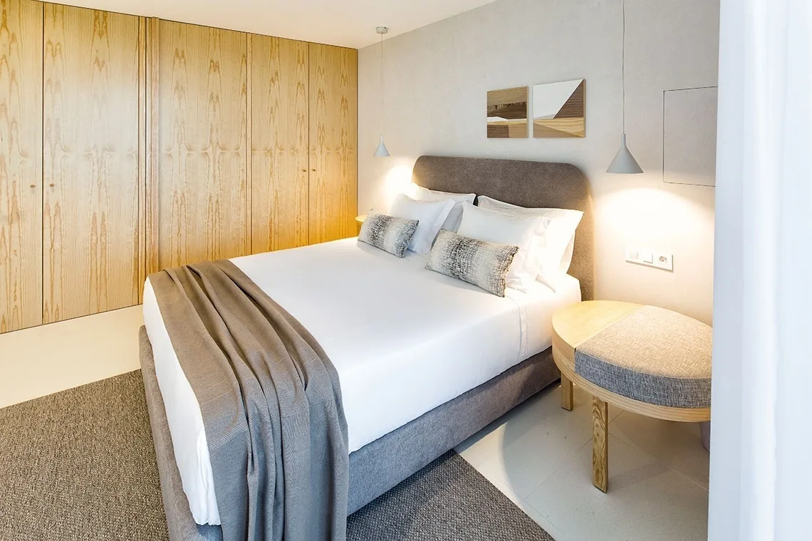 Guest room with a king bed and built-in wardrobe.