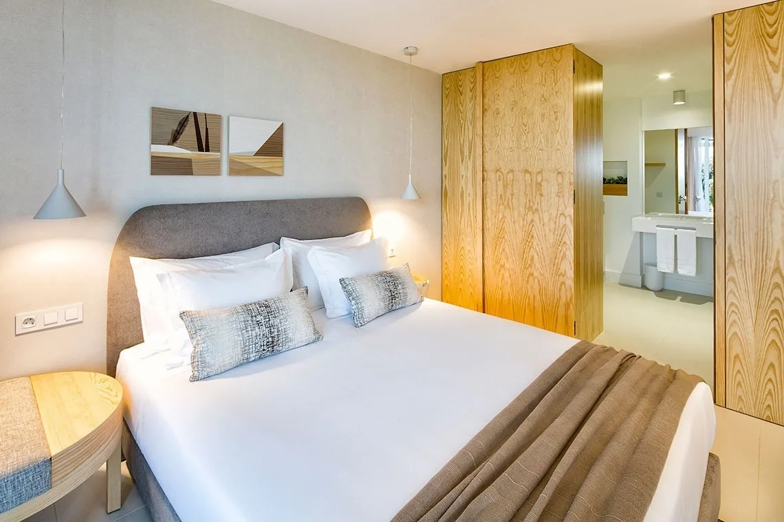 Guest room with a king bed and built-in wardrobe.