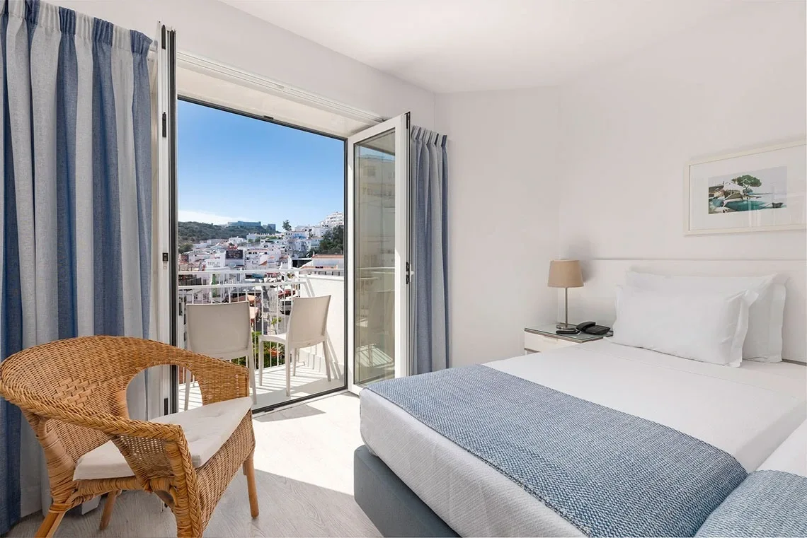 Hotel room with two beds and a chair