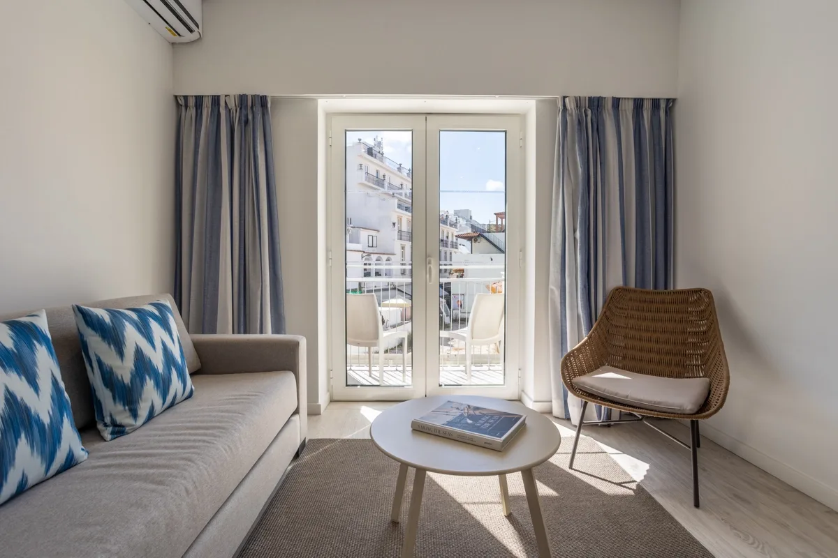 Hotel room with a bed, sofa, table and television