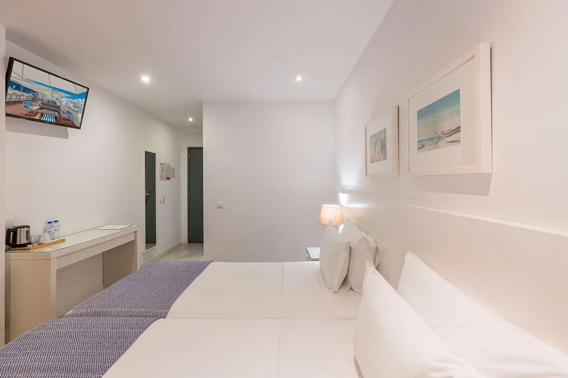 Hotel room with two beds and a table