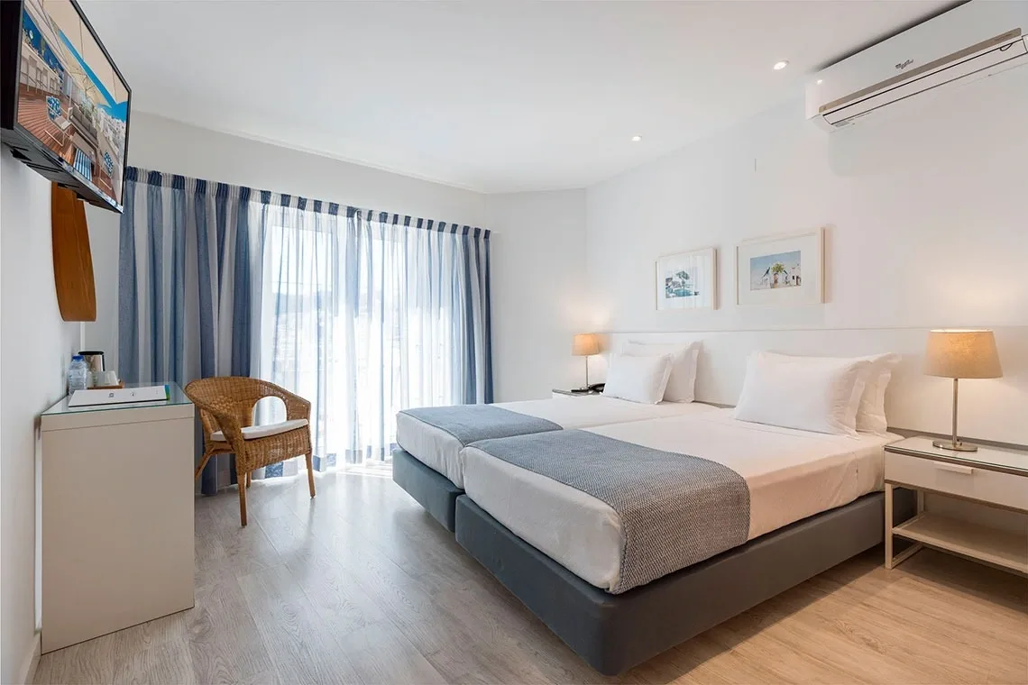 Hotel room with two beds and a chair