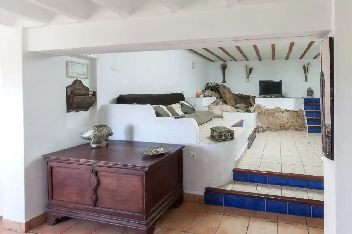 A rustic living area with built-in seating and a television.
