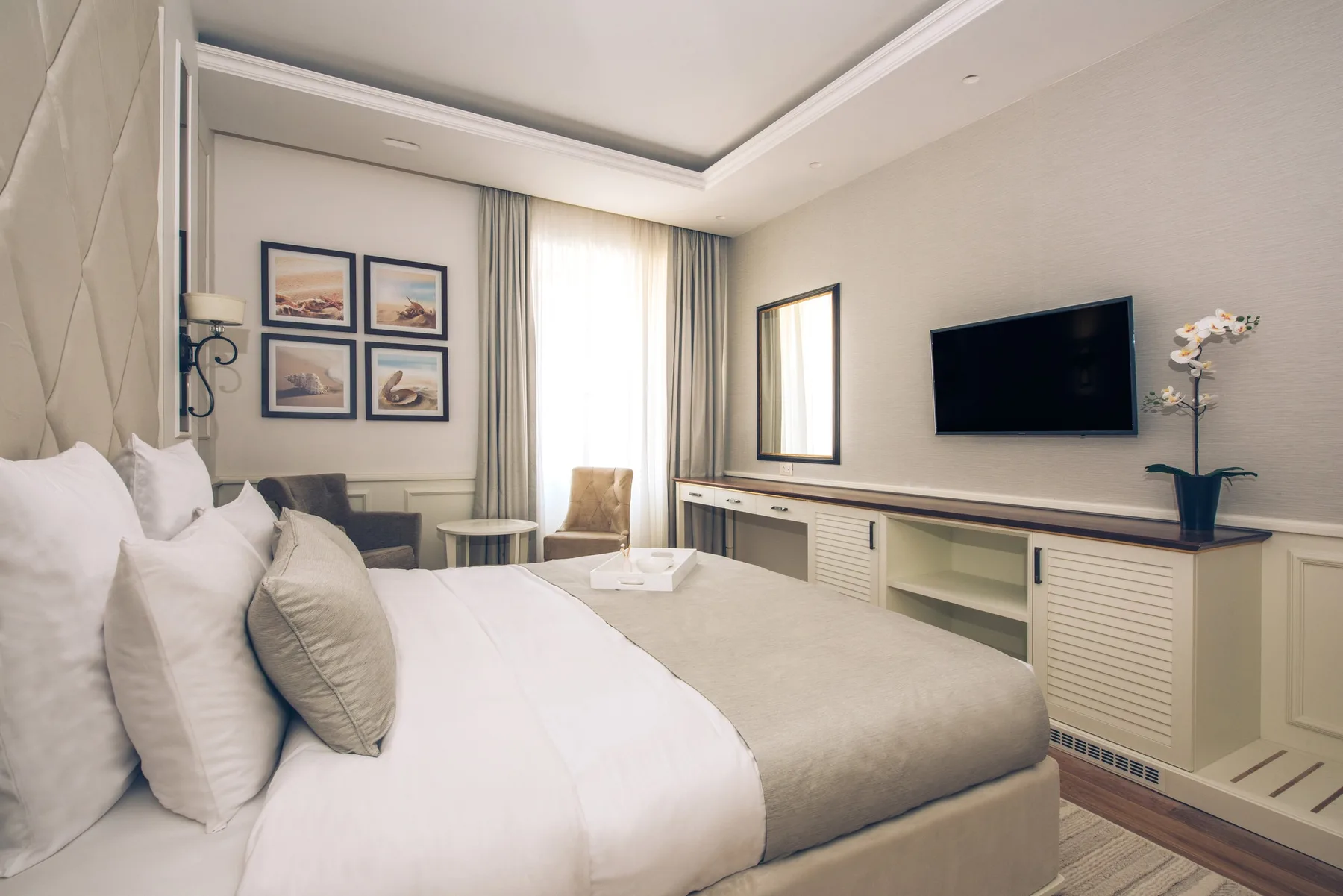 Hotel room with a double bed, desk and TV