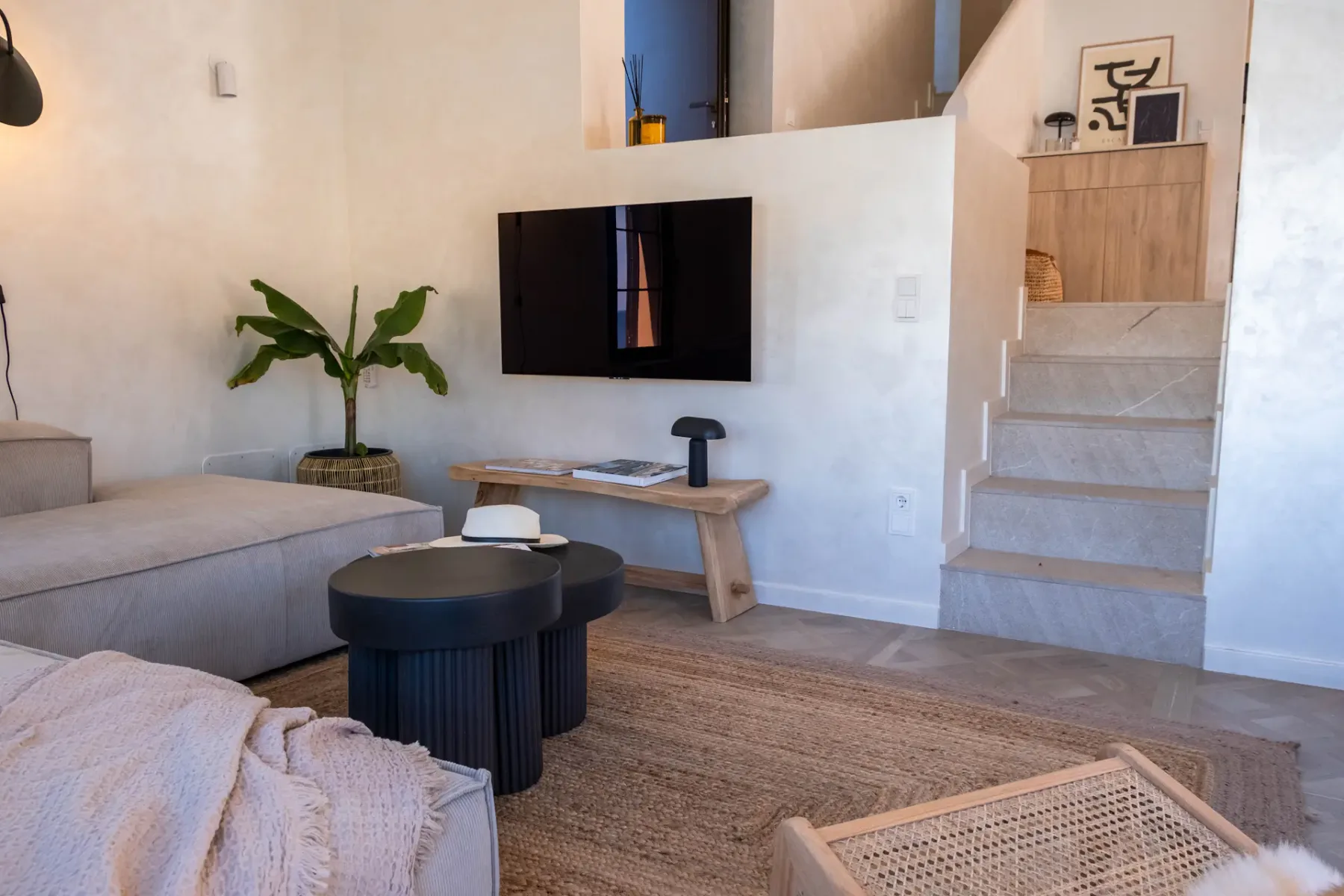 A living room with a television, seating, and a coffee table.