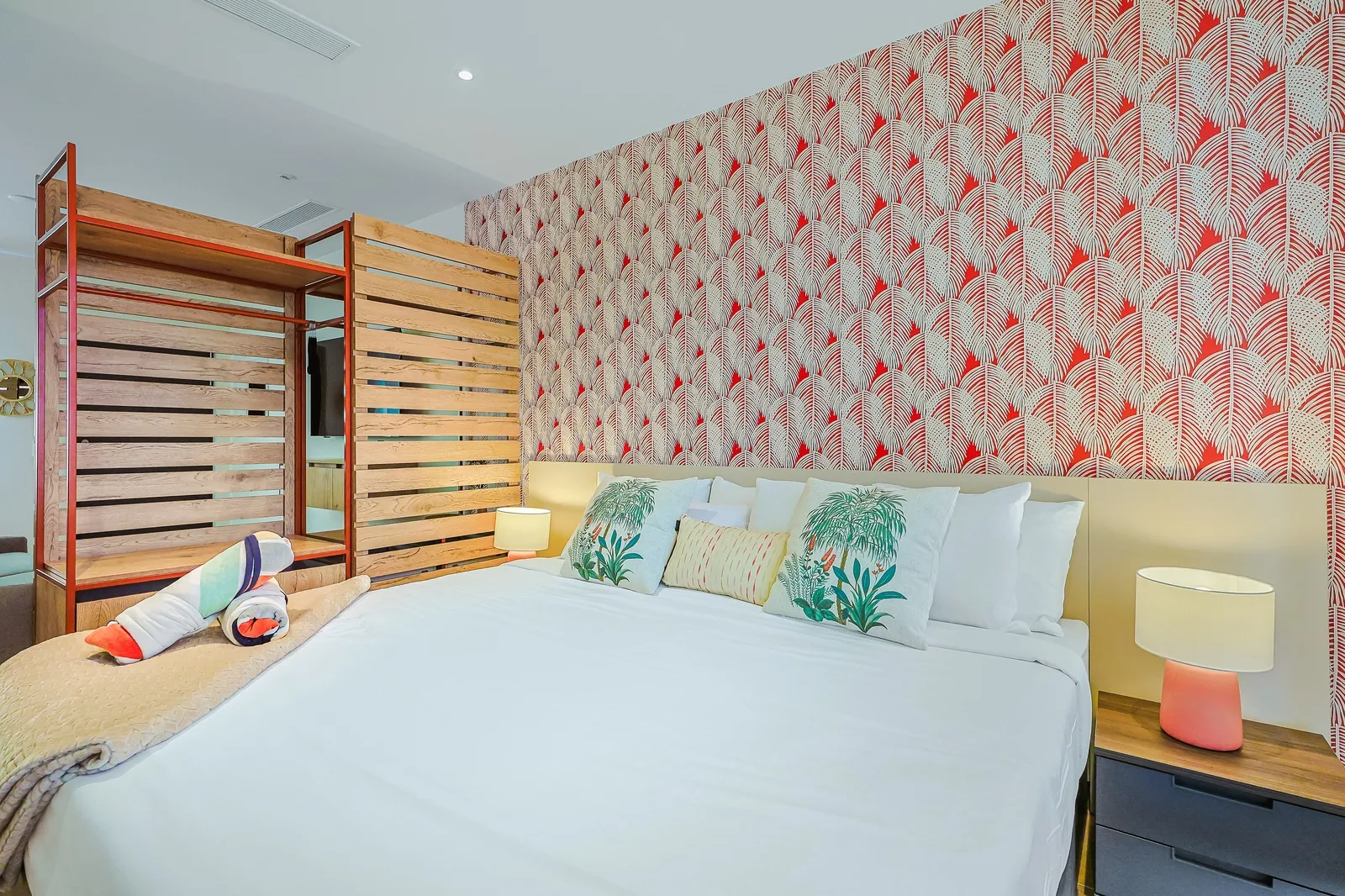 A serene and stylish bedroom retreat featuring a plush king size bed, natural wooden accents add warmth and character to the space, perfect to relax and recharge during your stay.