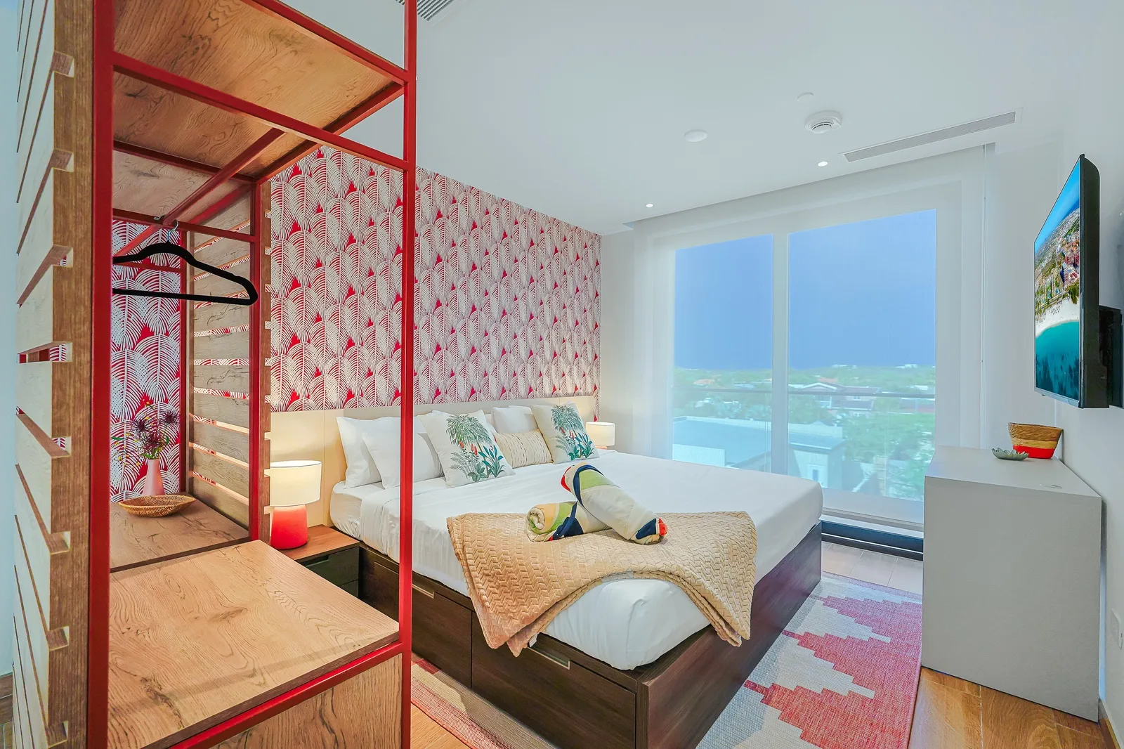 Unwind in your bright coastal retreat with plush bedding, tropical accents, and floor-to-ceiling windows that flood the space with natural light. Your private balcony overlooks the properties neighborhood.