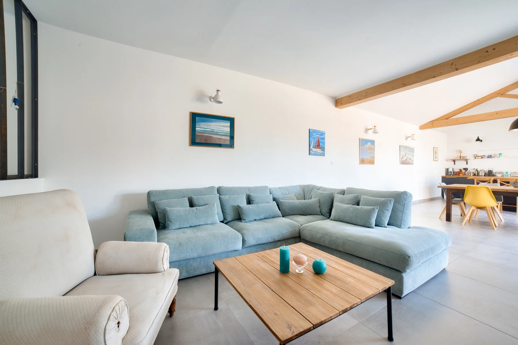 Bright living room with sectional seating and a wooden coffee table.