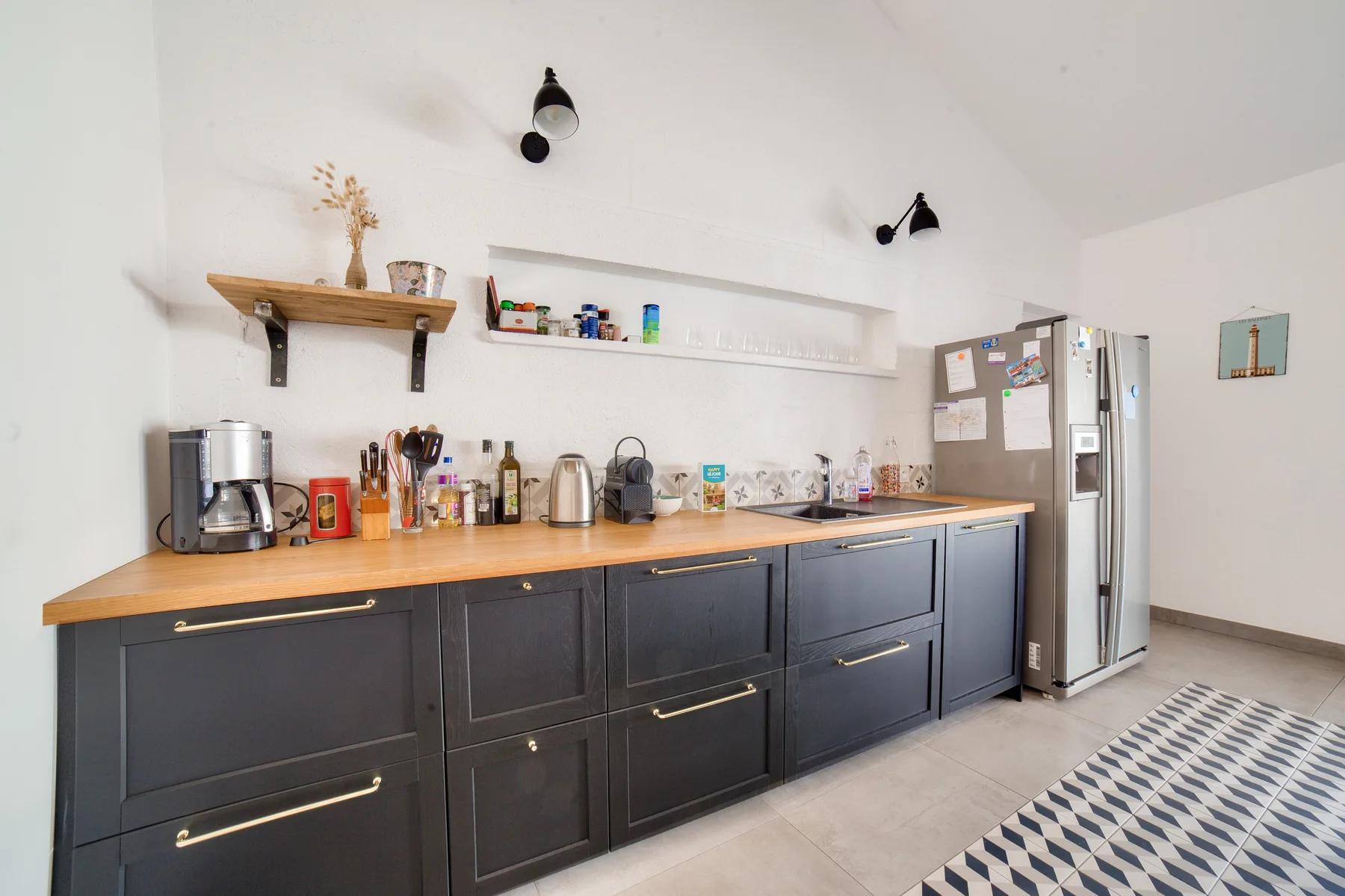 A kitchen counter with dark cabinets, appliances, and a refrigerator.