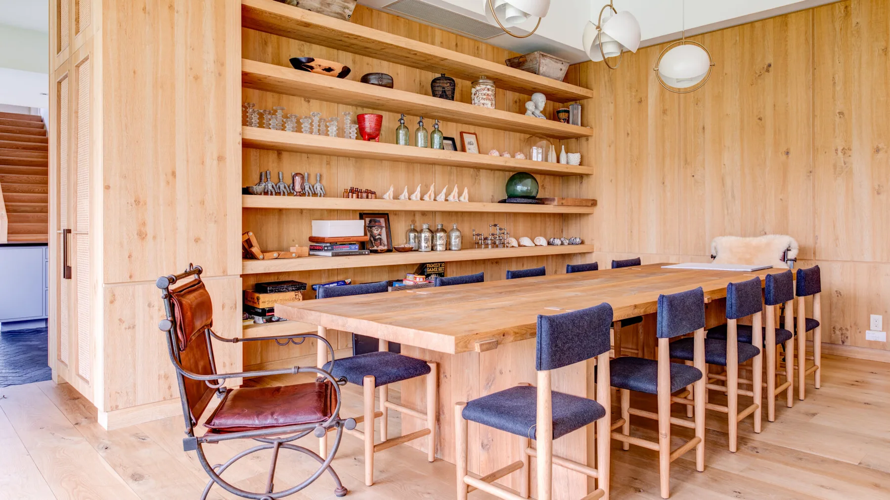 A wood-paneled dining room with a long table and chairs.