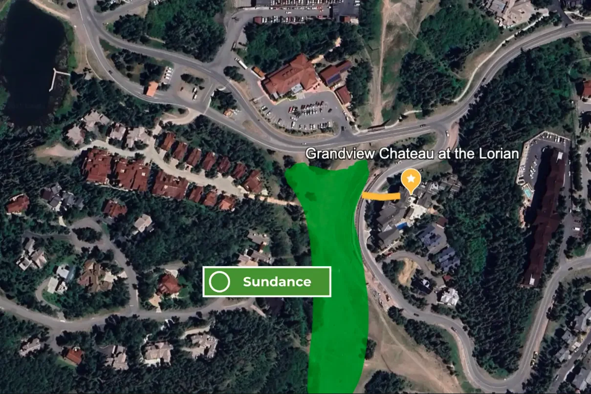 Aerial map view of wooded surroundings, roads, and nearby buildings.