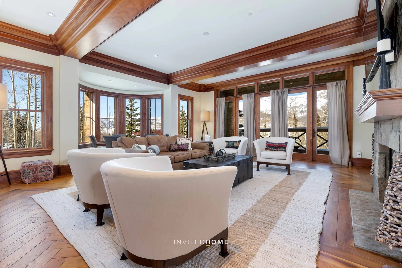 A spacious living room with seating arranged around a central coffee table.