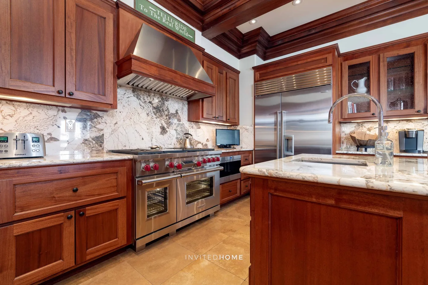 A spacious kitchen with dark wood cabinetry and a large central island.