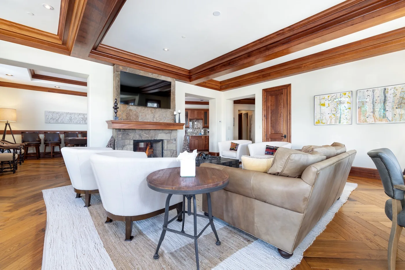 A bright living room with seating around a coffee table and a fireplace.
