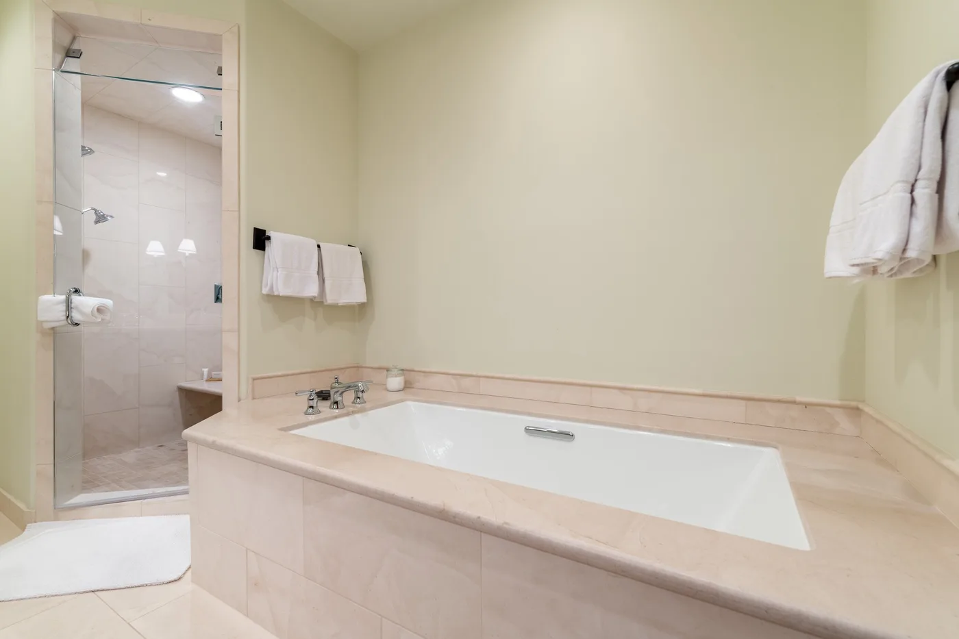 A bathroom with a bathtub and a glass-enclosed shower.