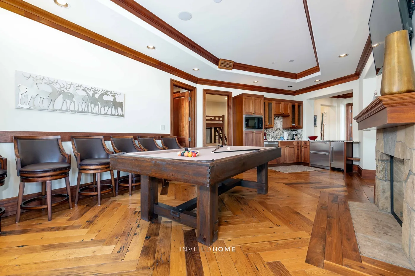 A spacious kitchen and dining area with a long table and bar seating.