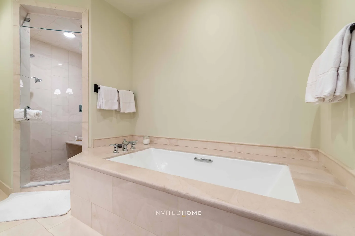 A bathroom with a bathtub and a glass-enclosed shower.