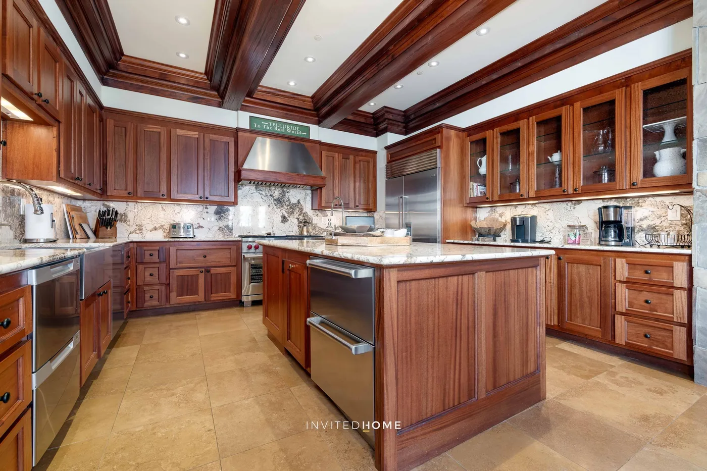 A spacious kitchen with dark wood cabinets and a central island.