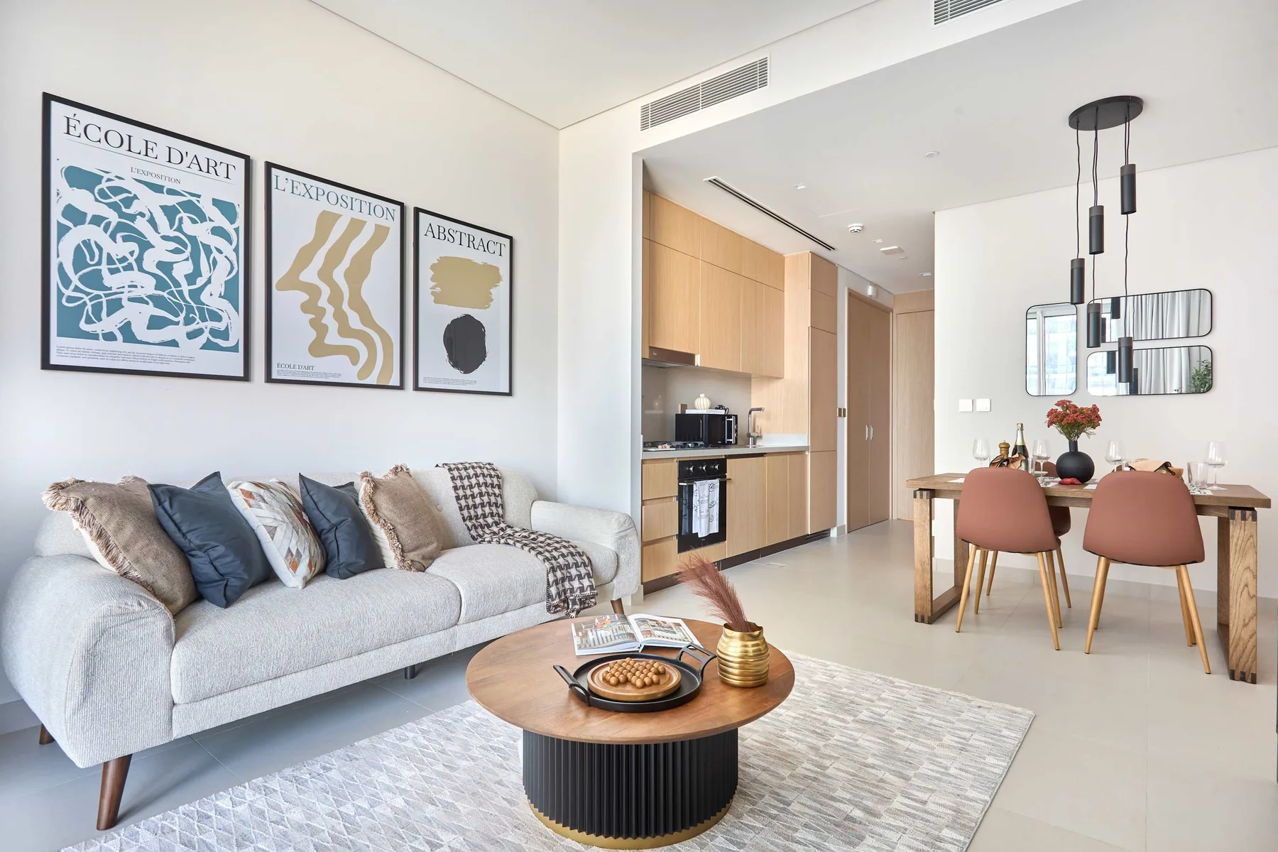 A bright living and dining area features a sofa, coffee table, and dining table.