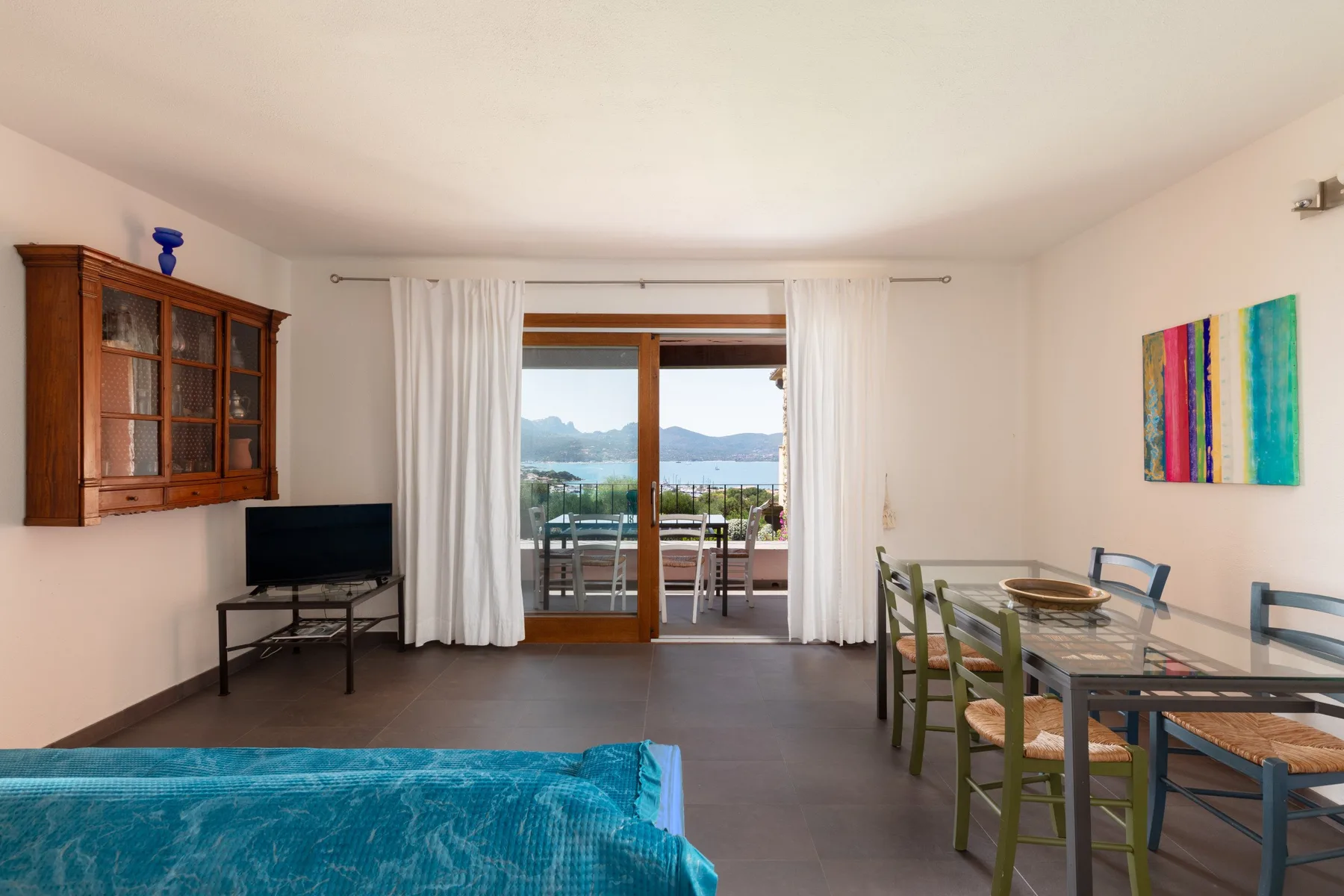 Una luminosa sala de estar y comedor se abre a un balcón con vistas al agua.