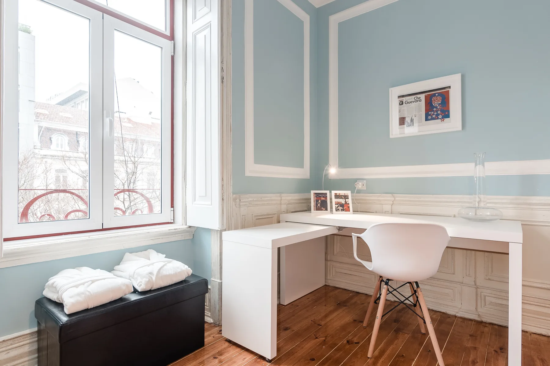A bright workspace with a white desk and a large window.