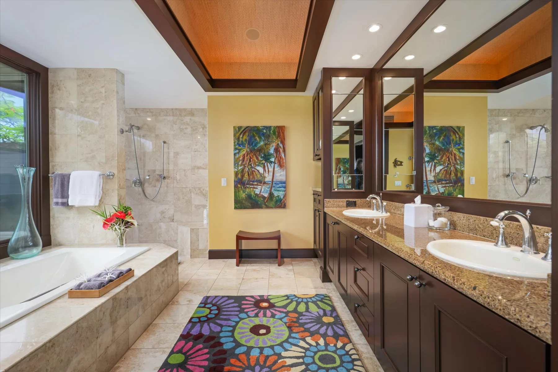 A spacious bathroom with a bathtub, walk-in shower, and long vanity.