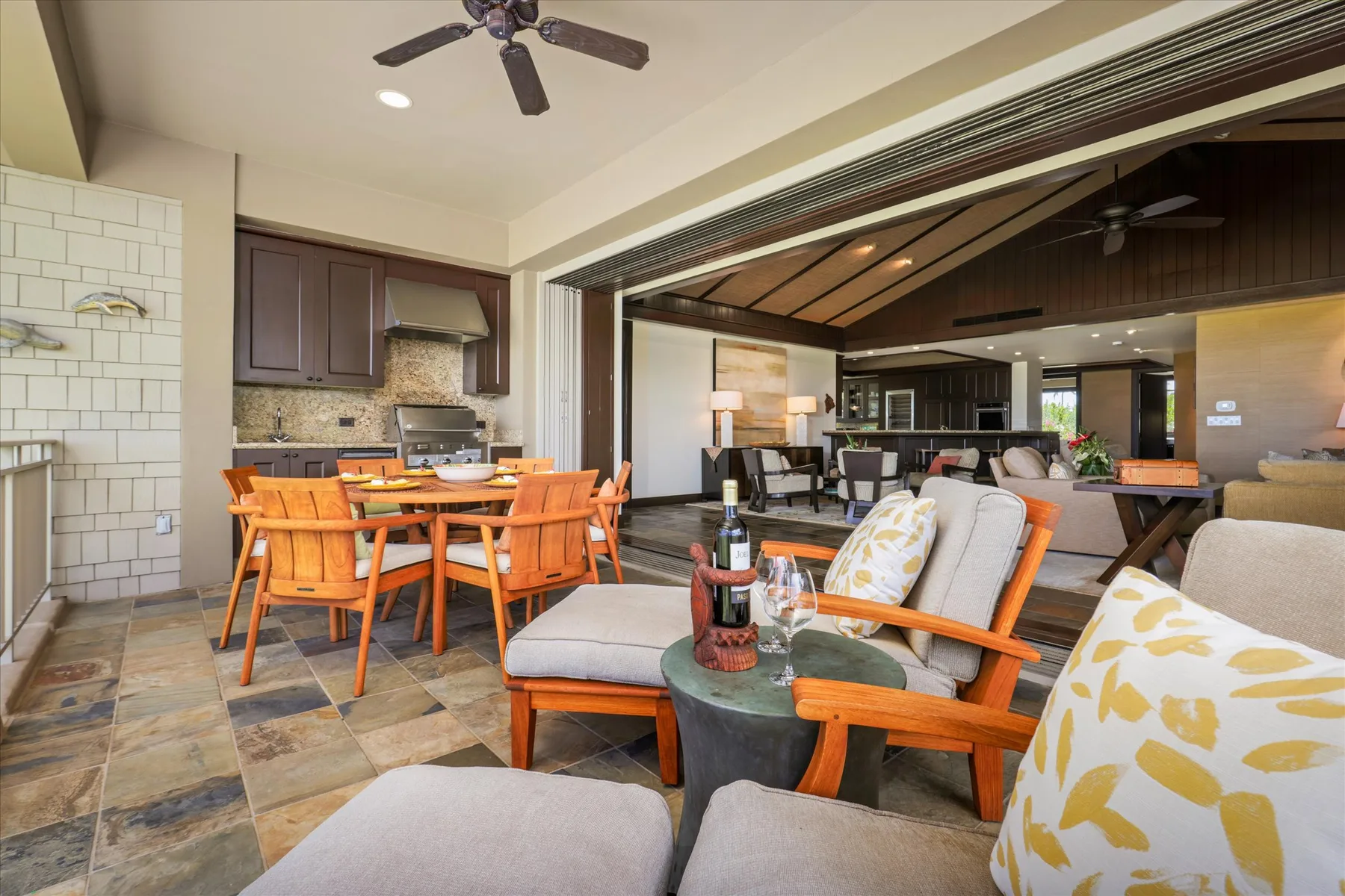 An open-plan living and dining area with a kitchen and cushioned seating.