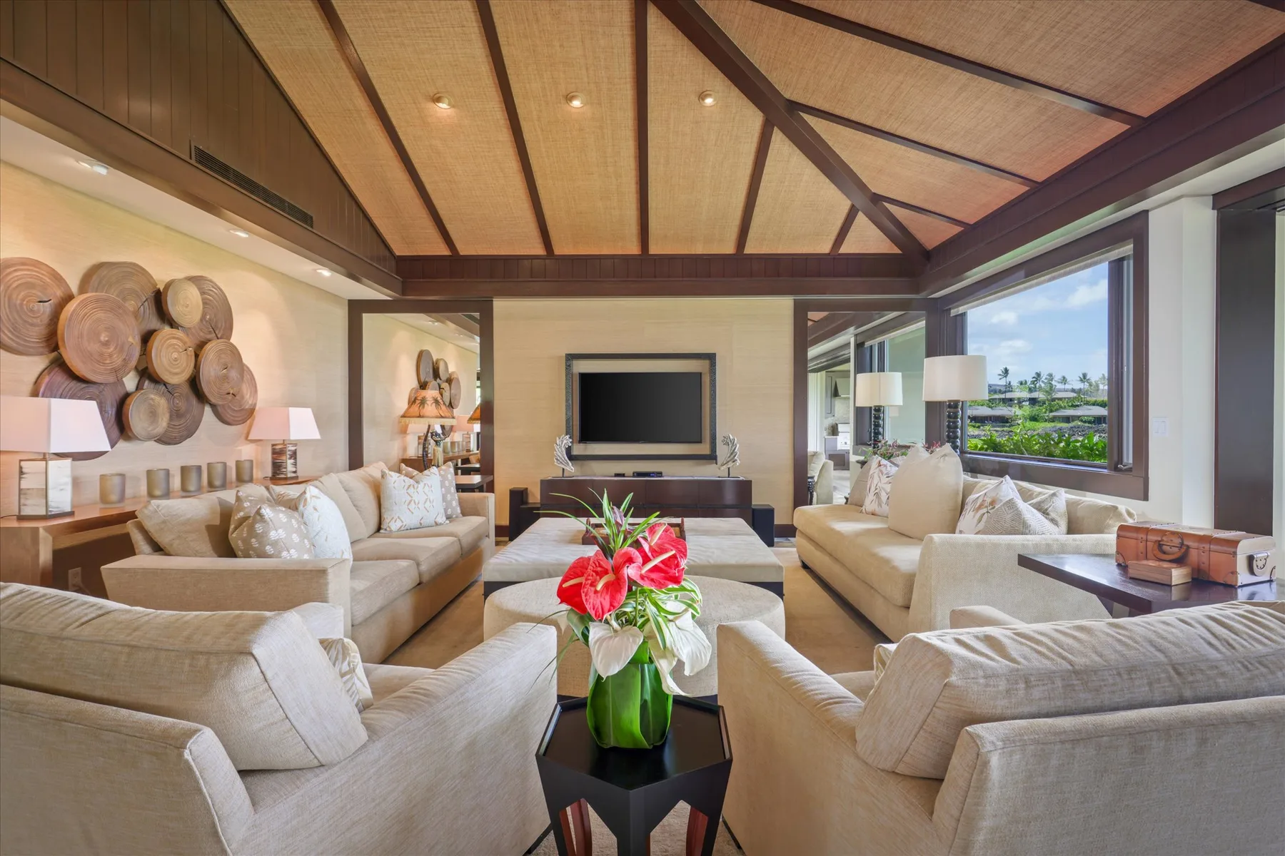 A living room with sofas arranged around a coffee table and television.
