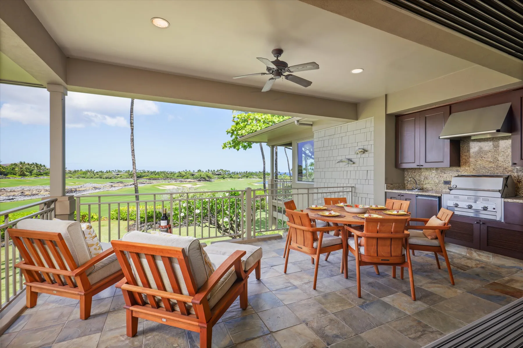 A covered outdoor dining area with wooden seating and a view of greenery.
