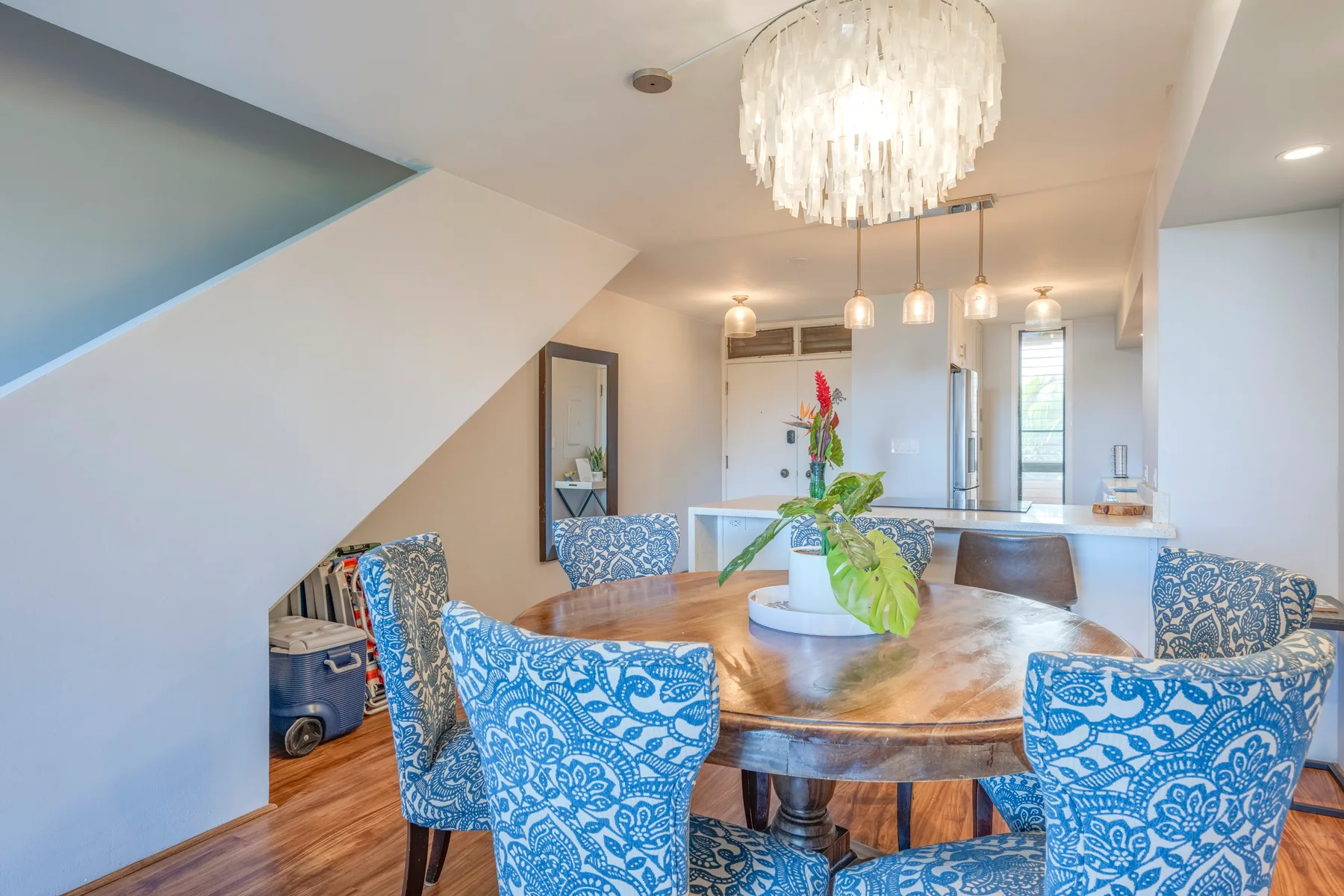 A dining area with a round wooden table and patterned seating.