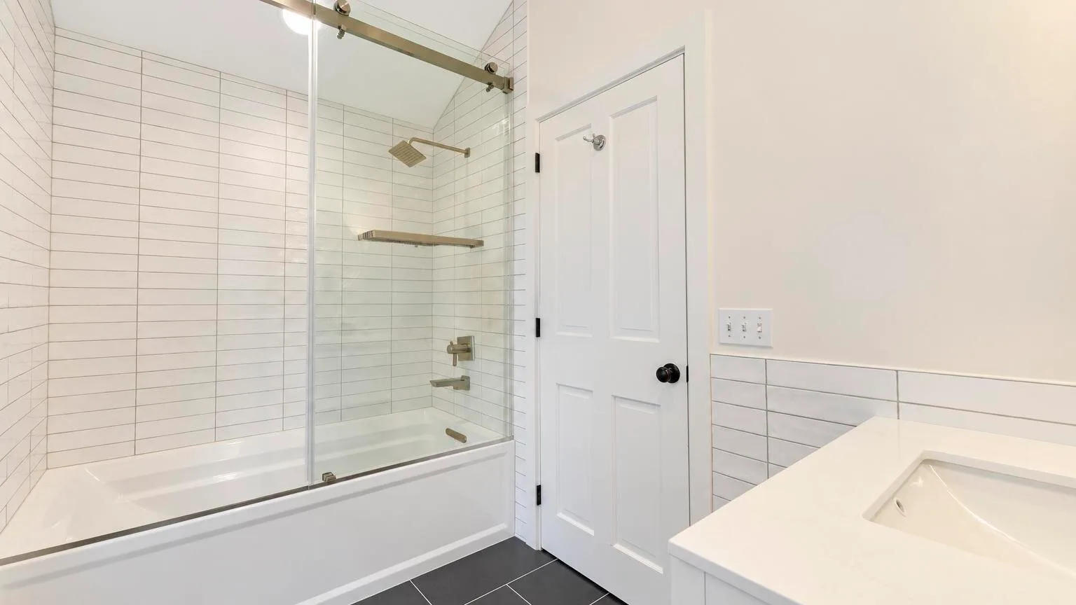 A bathroom with a bathtub and a separate sink.
