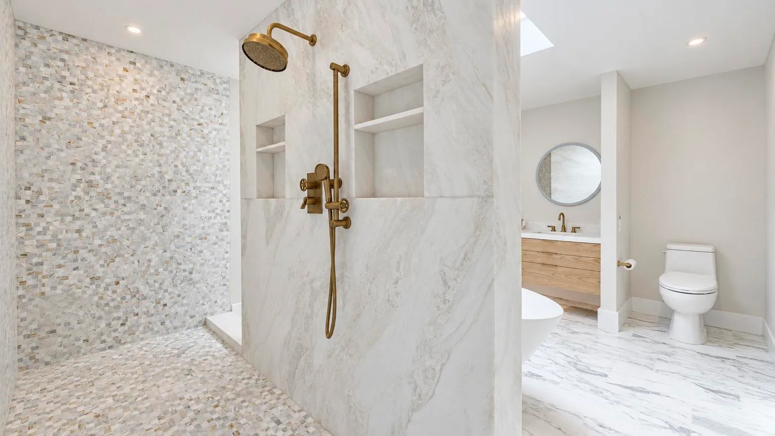 A bright bathroom with a walk-in shower and a vanity area.