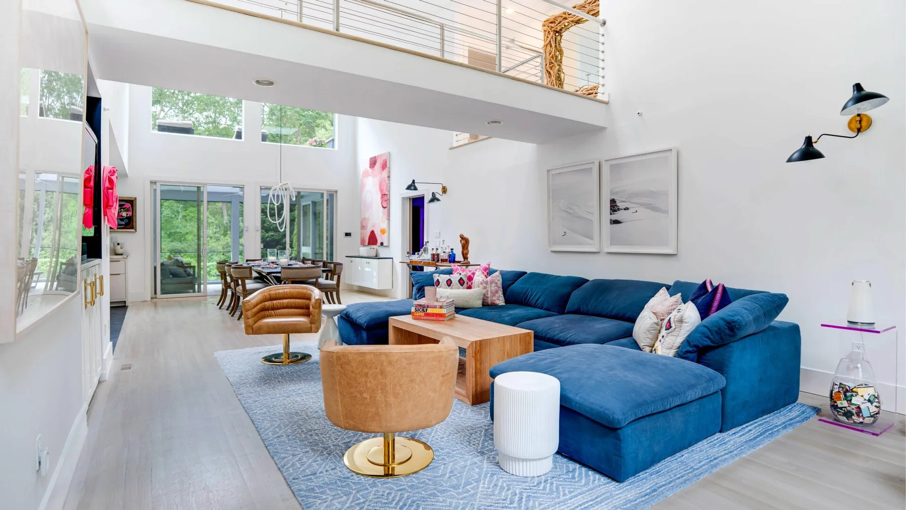 A bright living room with blue seating arranged around a wooden coffee table.