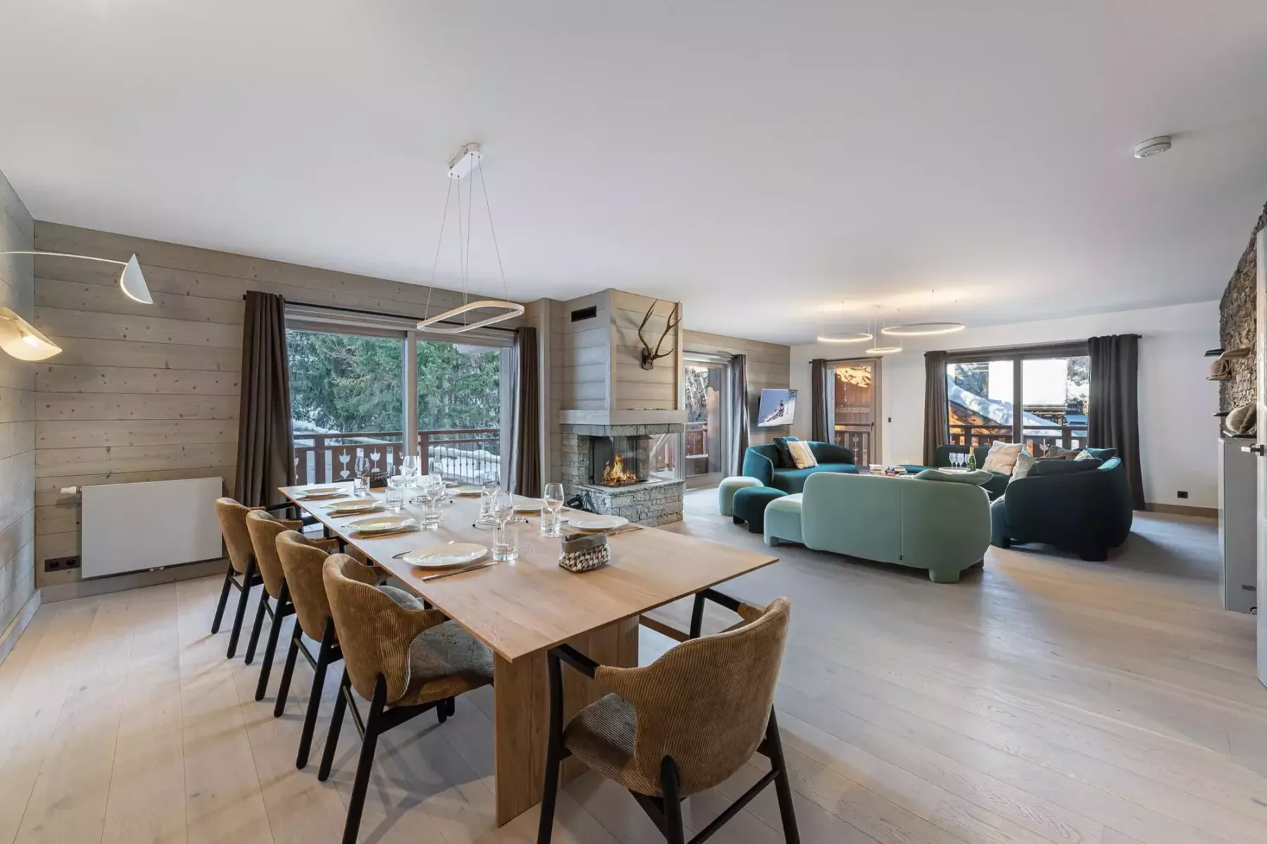 An open-plan living and dining room with a long table and seating area.