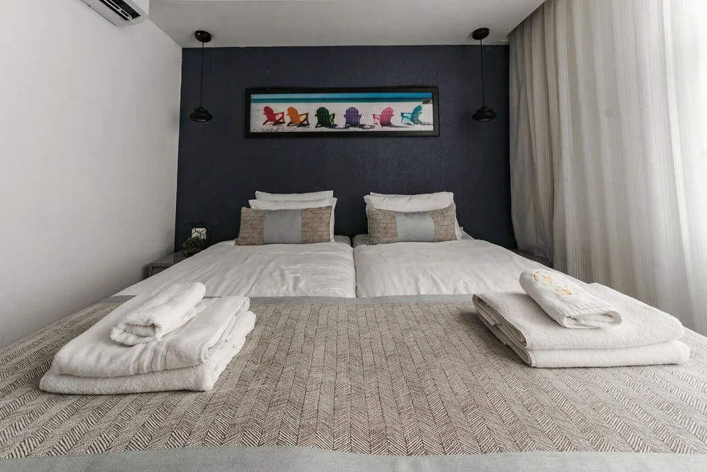 Twin beds and blue headboard